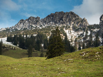 Scenic view of mountains against cloudy sky