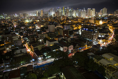 High angle view of illuminated cityscape against sky at night