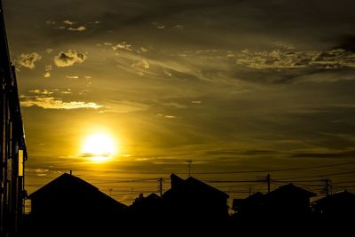 Low angle view of silhouette buildings against sky at sunset