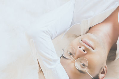 High angle view of woman lying on bed