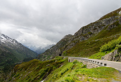 Road by mountain against sky