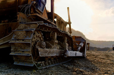 View of an abandoned car on field