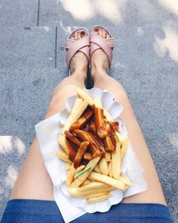 Low section of woman with french fries