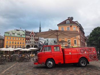 Vintage car on street against buildings in city