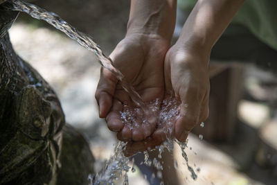 Close-up of hand holding water