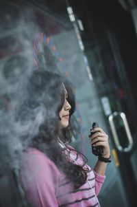 Close-up of young woman photographing with mobile phone