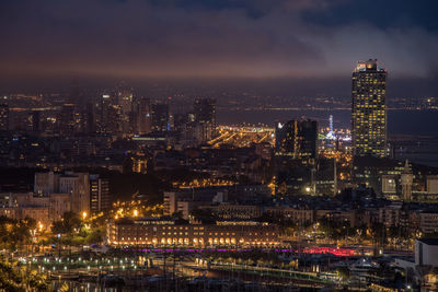 High angle view of illuminated city buildings at night