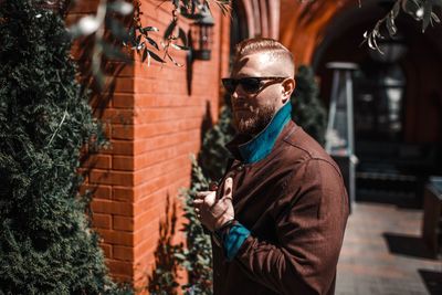 Man holding umbrella standing outdoors