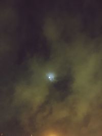 Low angle view of cloudy sky at night