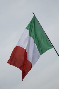 Low angle view of italian flags against clear sky