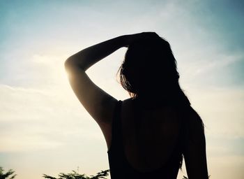 Low angle view of woman against clear sky