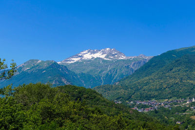 Scenic view of mountains against clear blue sky