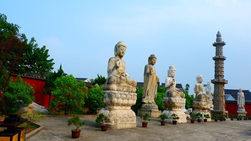 Statue in temple against building