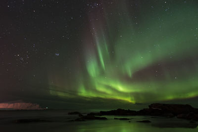 Scenic view of lake against sky at night