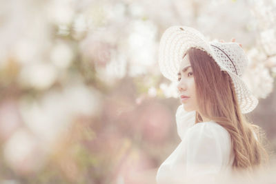 Portrait of young woman wearing hat