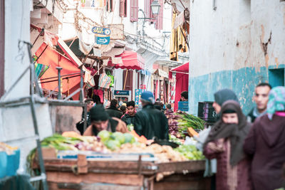 People at market stall in city