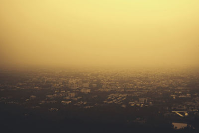 High angle view of buildings against clear sky at dusk