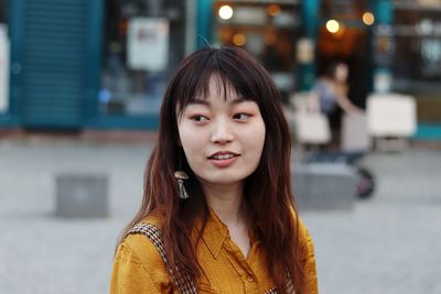 Close-up of woman looking away in city