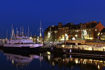 View of illuminated buildings against clear sky at night