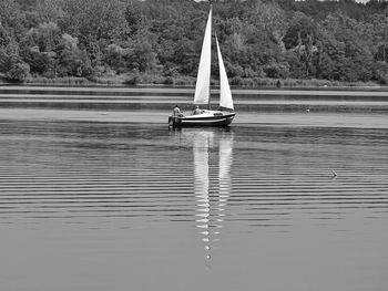Sailboat sailing on lake