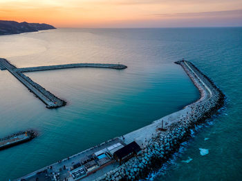 High angle view of bridge over sea against sky during sunset
