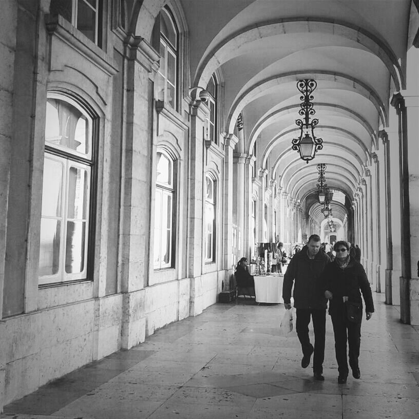 indoors, architecture, arch, men, built structure, lifestyles, person, full length, walking, rear view, leisure activity, the way forward, corridor, architectural column, casual clothing, day, incidental people