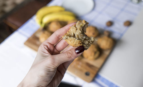 High angle view of person holding food on table