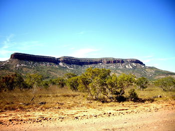 View of mountain range against blue sky