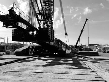 Crane at construction site against sky