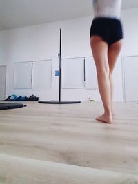 Low section of woman standing on floor at home