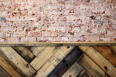 Wooden plank and brick wall