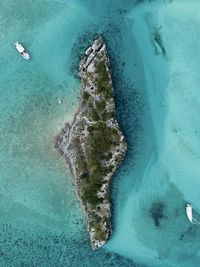 Aerial view of boats moored at sea by island