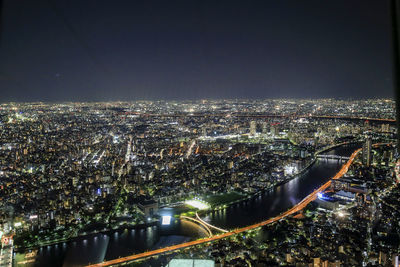 High angle view of illuminated buildings in city at night