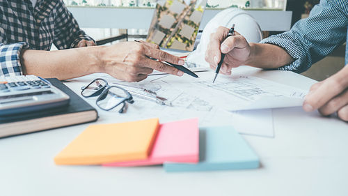 Midsection of man working on table