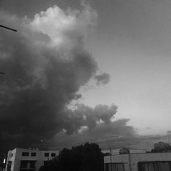 Low angle view of building against cloudy sky