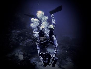 Scuba diver taking photos under water