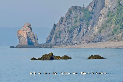 Panoramic view of rocks in sea against sky