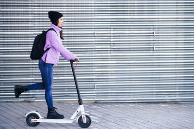 Full length of woman riding skateboard