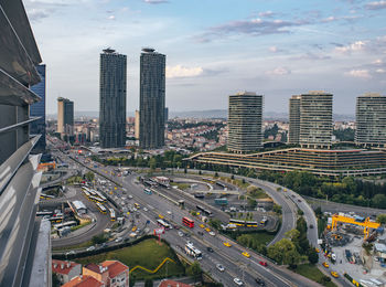 High angle view of traffic on road amidst buildings in city