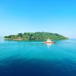 Scenic view of sea against clear blue sky