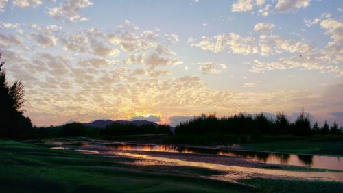 Scenic view of landscape against sky at sunset