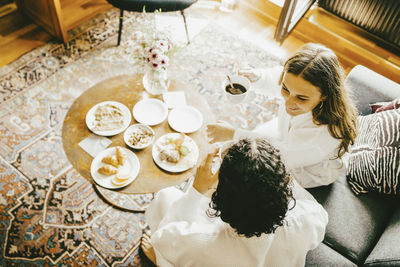 High angle view of young couple having breakfast in hotel room