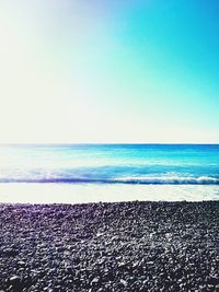 Scenic view of beach against blue sky