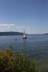 Sailboat sailing on sea against sky