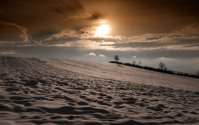 Scenic view of beach against sky during sunset