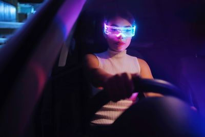 Portrait of young woman in car