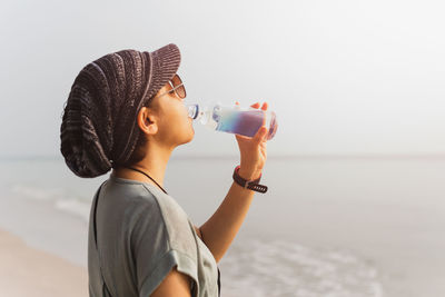 Tourist woman hydrating drinking water from bottle