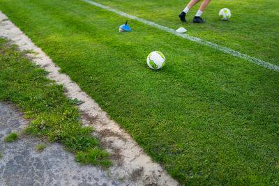 Low section of man playing soccer on field