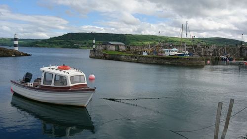 Boats moored in sea against sky
