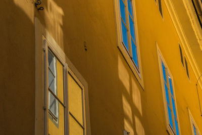 Low angle view of yellow wall